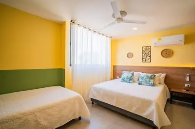 a bedroom with two beds and a ceiling fan at Laguito Houstel Large in Cartagena de Indias