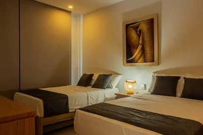 a room with two beds and a painting on the wall at APARTAMENTO EN CARTAGENA CON SALiDA DIRECTA A LA PLAYA in Cartagena de Indias