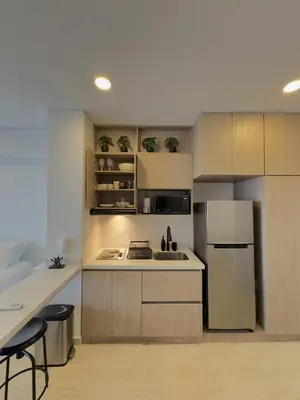 a kitchen with stainless steel appliances and wooden cabinets at Apartamento suite Cartagena - Cartagena Beach Resort in Cartagena de Indias