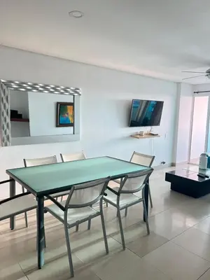 a dining room with a green table and chairs at Apartamento con vista al mar in Cartagena de Indias