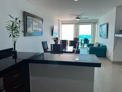 a living room with a kitchen and a dining room at Apartamento con vista al mar in Cartagena de Indias