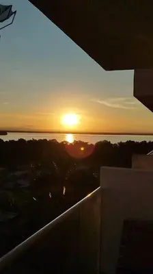 a sunset over the ocean from a balcony of a building at Cartagena Martinique - Hermoso apartamento con Jacuzzi en el Balcón! in Cartagena de Indias