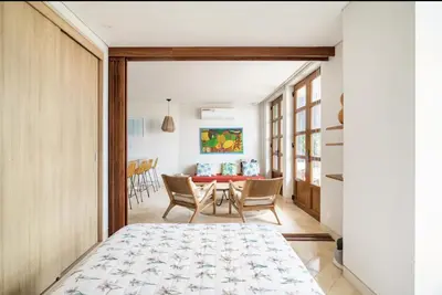 a bedroom with a bed and a dining room at Sunny new apt in the Old City in Cartagena de Indias