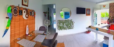 a living room with a desk and chairs and a wall with graffiti at Apartamento sereno, cerca al mar in El Porvenir