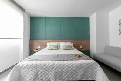 a bedroom with a large bed and a couch at Casa Gracia Hotel Boutique in Cartagena de Indias