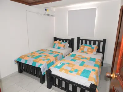two beds sitting next to each other in a room at Apartment Nurita Boston in Barranquilla