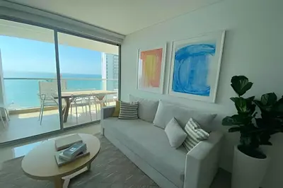 a living room with a couch and a table at Modern 2BR next to the Walled City+Oceanside View in Cartagena de Indias