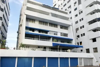 an apartment building with a blue garage in front of it at Gloria Al Laguito Duplex in Cartagena de Indias
