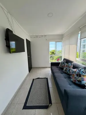 a living room with a blue couch and a flat screen tv at Apartamento 2 habitaciones Paraiso, by Accommdo360 in Barranquilla