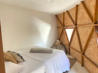 a bedroom with a bed in a room with a window at Casa de playa Kommox Beach in Cartagena de Indias