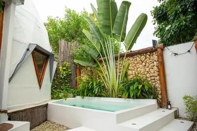 a bath tub in a garden with a plant at Casa de playa Kommox Beach in Cartagena de Indias