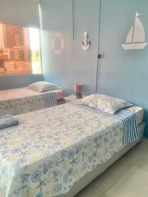 two beds sitting next to each other in a room at Apartamento Acogedor en Cartagena in Cartagena de Indias