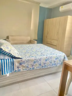 a bedroom with a bed and a wooden cabinet at Apartamento Acogedor en Cartagena in Cartagena de Indias