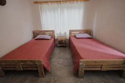 two beds with red sheets in a room at Apartamento Atlantic 111 in La Perdiz