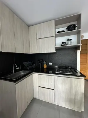 a kitchen with wooden cabinets and a sink and a stove at 203 Apartamento Frente al Mar in San Bernardo del Viento