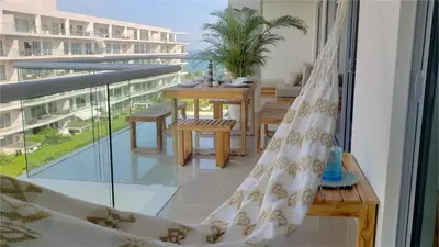 a room with a balcony with a table and chairs at Apartamento Cartagena in Cartagena de Indias