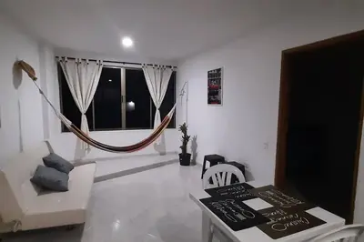 a living room with a hammock in the middle of the room at Cómodo Ap Frente al mar, cerca a la murallas in Cartagena de Indias