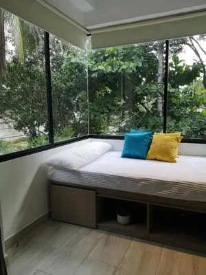 a bed in a room with a large window at Azul in Santa Marta