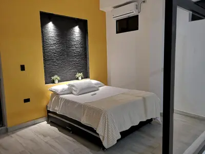 a bedroom with a large bed with a window at Azul in Santa Marta