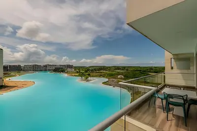 a view from the balcony of a resort with a large swimming pool at Lujoso A Estrenar/Oasis Laguna Cristalina 2BR in Los Arrayanes