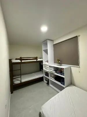 a bedroom with a bed and a flat screen tv at Cabaña salgar - la casa de la playa in Puerto Salgar