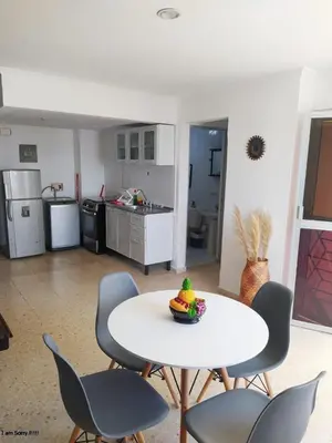 a room with a table and chairs and a kitchen at apto con vista al mar piso 11- in Cartagena de Indias