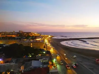 a view of a beach at night with cars at apto con vista al mar piso 11- in Cartagena de Indias