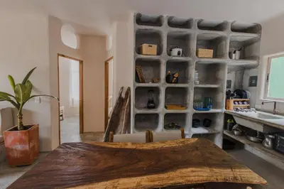 a dining room with a table and a shelf at Apartamento Atlantic 112 in La Perdiz