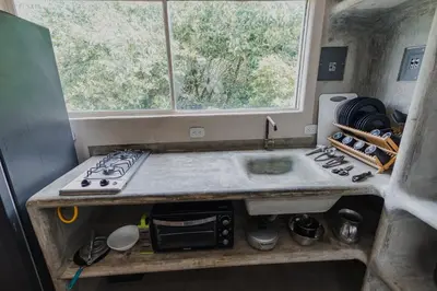 a kitchen with a sink and a stove and a window at Apartamento Atlantic 211 in La Perdiz