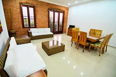 a living room with a table and a dining room at Te la mereces, frente al mar in Cartagena de Indias