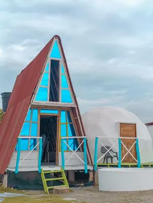 a house with a triangular roof and two domes at Barracuda Glamping in Paso Nuevo