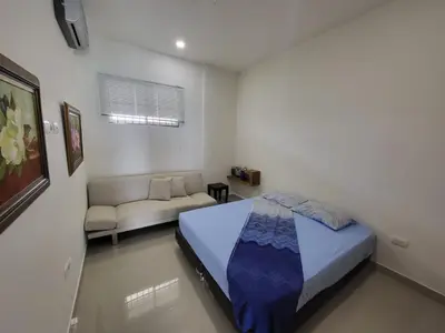 a bedroom with a bed and a couch in it at Apartamentos Mi Reserva OK - Bahía Marina in Coveñas