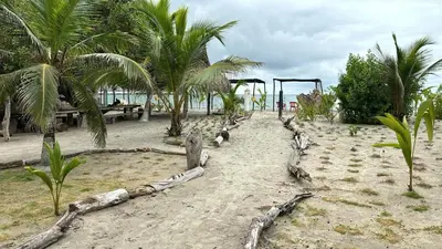 a playground on a beach with palm trees at Apartamento Atlantic 311 in La Perdiz