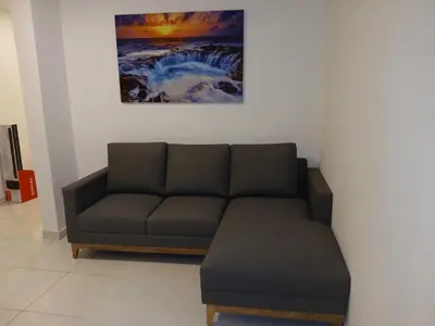 a living room with a couch and a painting on the wall at Casa Marbella in Cartagena de Indias
