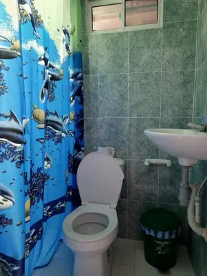 a bathroom with a toilet and a sink at Sharly House in Cartagena de Indias