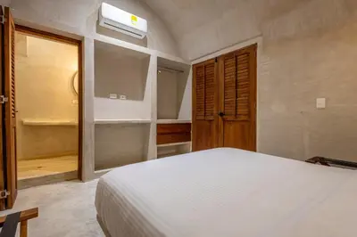 a bedroom with a white bed and a window at Casa Fernandez By SoHo in Cartagena de Indias