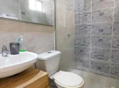 a bathroom with a toilet and a sink and a shower at Apartamento en alameda del Río Conjunto Azulejo in Barranquilla