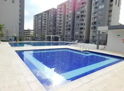 a large blue swimming pool in front of some buildings at Apartamento en alameda del Río Conjunto Azulejo in Barranquilla