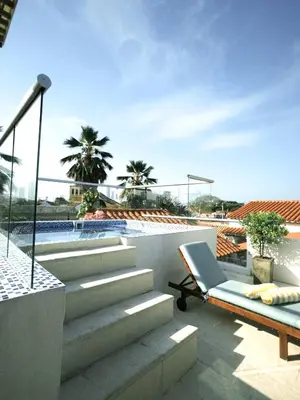 a balcony with a chair and a swimming pool at Casa Guerrero in Cartagena de Indias