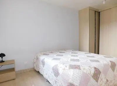 a bedroom with a bed with a quilt on it at Apartamento en alameda del Río in Barranquilla