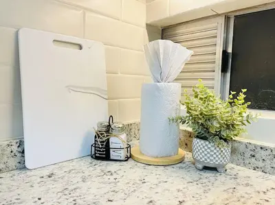 a white container sitting on a counter next to a refrigerator at Tropical Oasis Barranquilla in Barranquilla