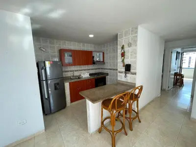 a kitchen with a counter and a refrigerator at Apartamentos En Edificio Portofino ICDI in Cartagena de Indias