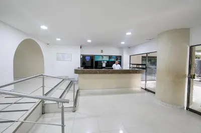 a man standing at a counter in a building at Apartamentos En Edificio Portofino ICDI in Cartagena de Indias
