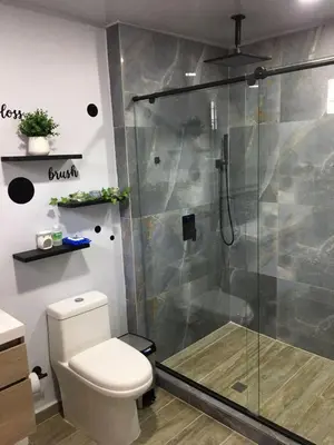 a bathroom with a toilet and a glass shower at El reposo real in Barranquilla