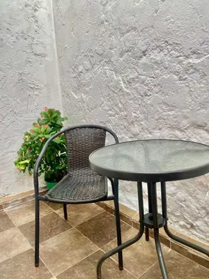 a table and a chair next to a table and a plant at Casa Centro Historico Hotel in Cartagena de Indias