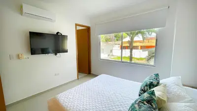 a bedroom with a bed and a flat screen tv at Hermoso Apartamento Frente al Mar 2 Habitaciones B12A in Coveñas
