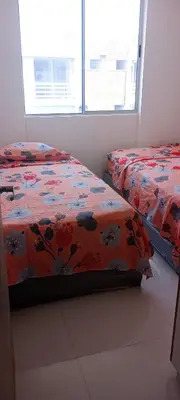 a bedroom with two beds and a window at Apartamento Manglar C Mallorquin Vista al Mar in Puerto Colombia