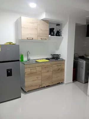 a kitchen with a sink and a refrigerator at Apartamento Manglar C Mallorquin Vista al Mar in Puerto Colombia
