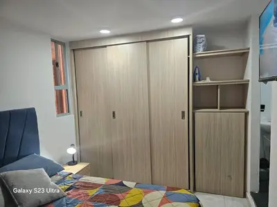 a bedroom with a closet and a bed and a cabinet at Hermoso apartamento familiar! exento de IVA in Barranquilla
