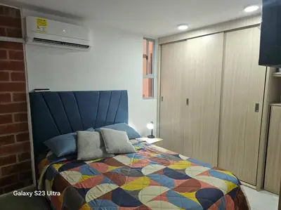 a bedroom with a bed with a colorful quilt at Hermoso apartamento familiar! exento de IVA in Barranquilla